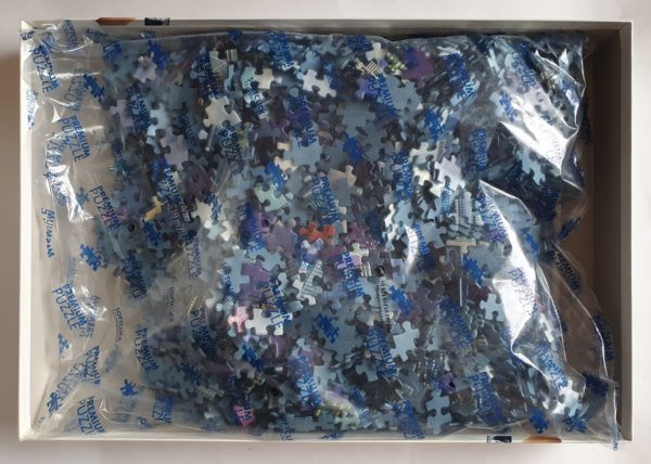 Image of the puzzle 2000, Ravensburger, World’s Highest Buildings, Garry Walton. Picture of the bag with pieces puzzle.