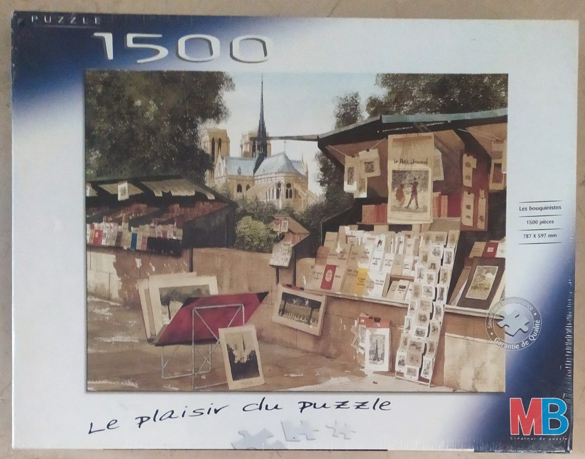 1500, MB, Les Bouquinistes, by Michael Duvoisin, Factory Sealed, Listed by Barebrain Image of the puzzle 1500, MB, Les Bouquinistes, by Michael Duvoisin, Factory Sealed, Picture of the box